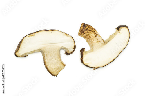 Group of two slices of fresh raw brown shiitake mushroom flatlay isolated on white.