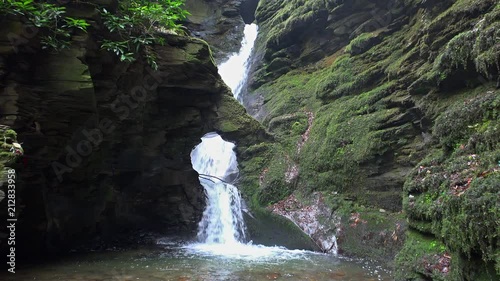 Cinemagraph of water flowing through a hole in a rock photo