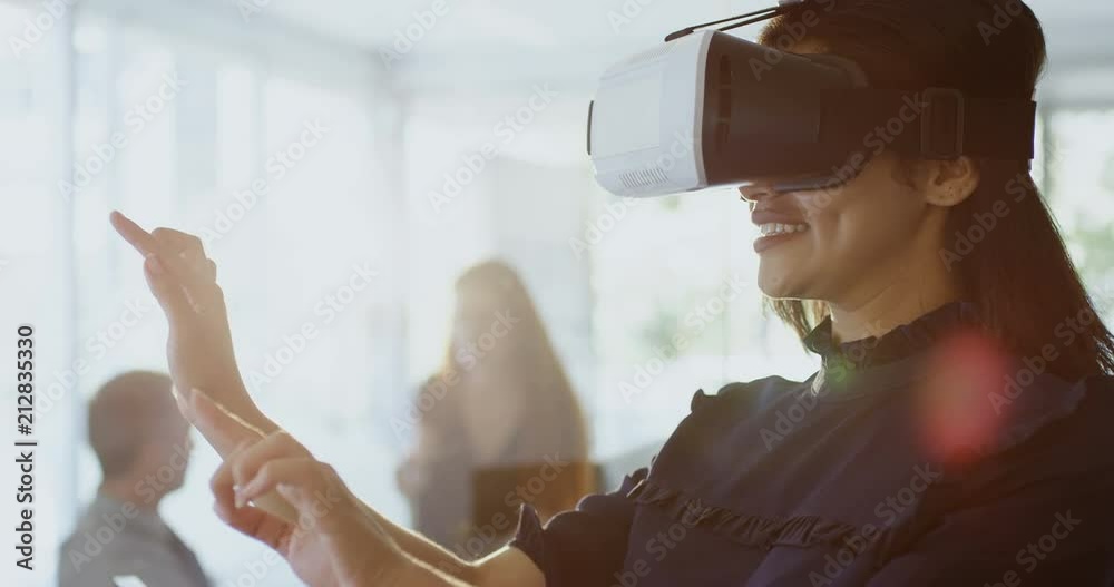 Businesswoman using virtual reality headset 4k