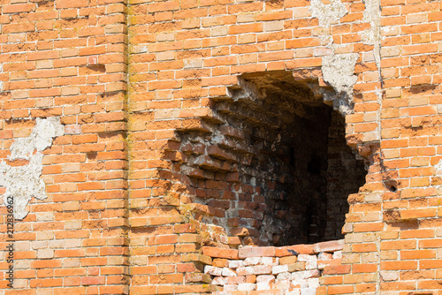 hole in old brick wall photo