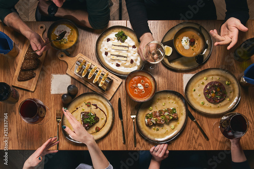 Table with food, top view. Group Of People Dining Concept