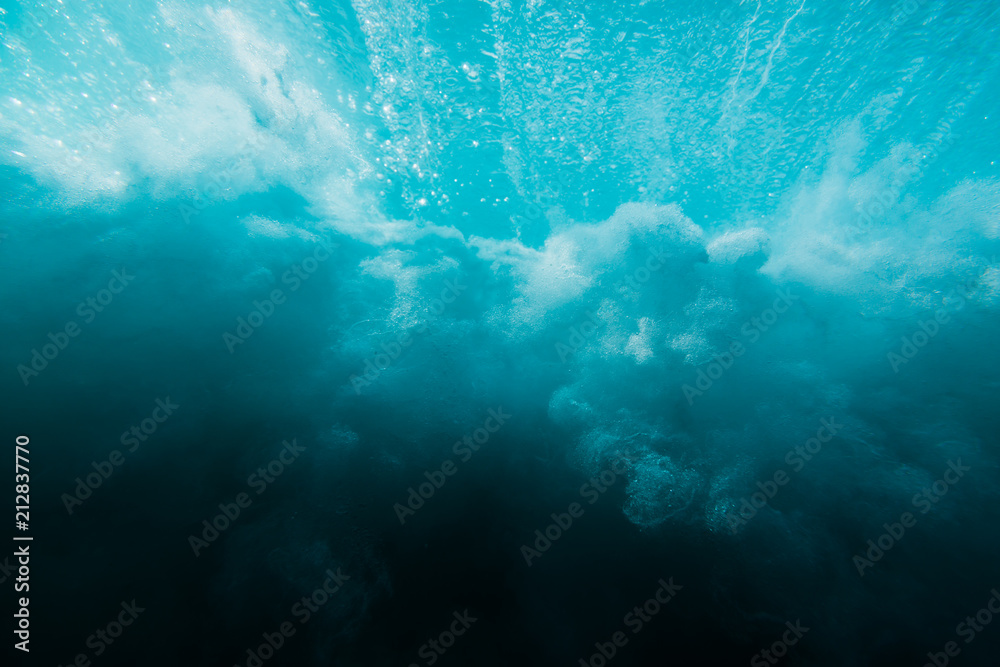 Obraz premium Breaking ocean wave is underwater. Ocean texture in underwater