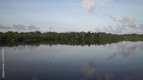 Symmetric reflection on peaceful lake in the early Florida morning photo