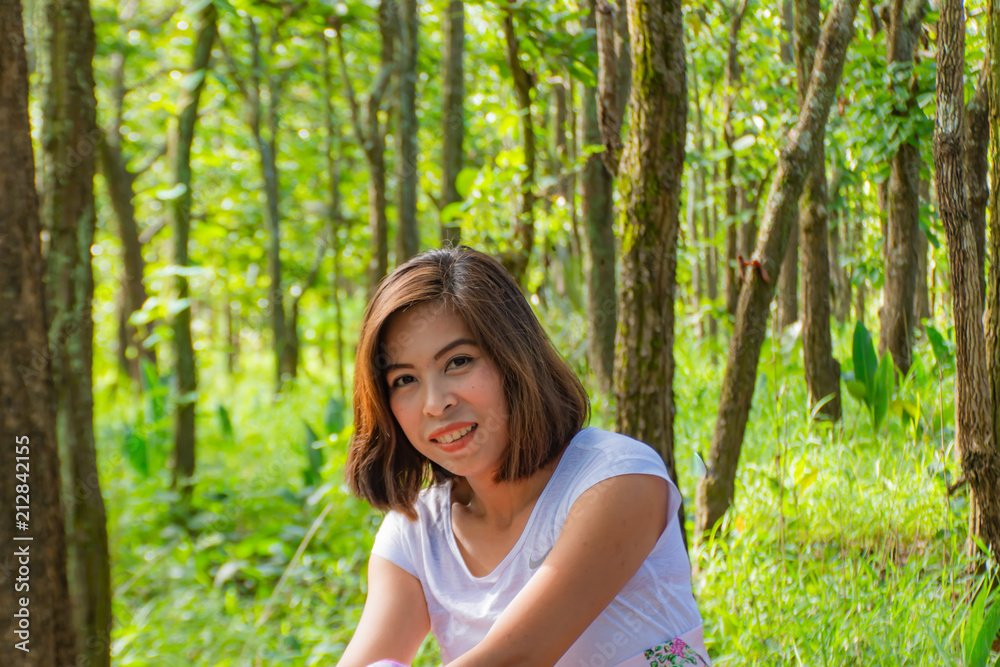 Portrait of Asian women. The background of green trees.