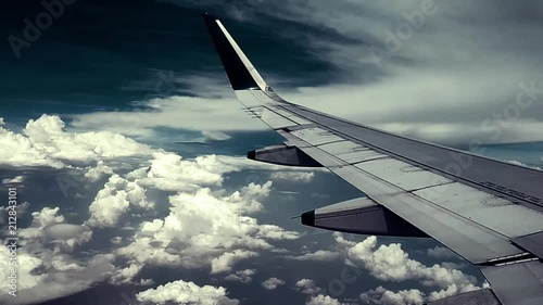 View of giant clouds through an airplane window photo