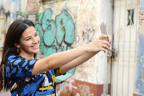 Portrait of a beautiful young woman taking a selfie