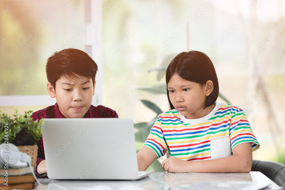 Asian child playing laptop computer computer together Asian child playing laptop computer computer together