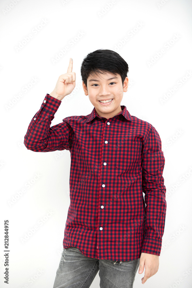 Asian boy smiling and pointing finger up . Asian boy smiling and pointing finger up .