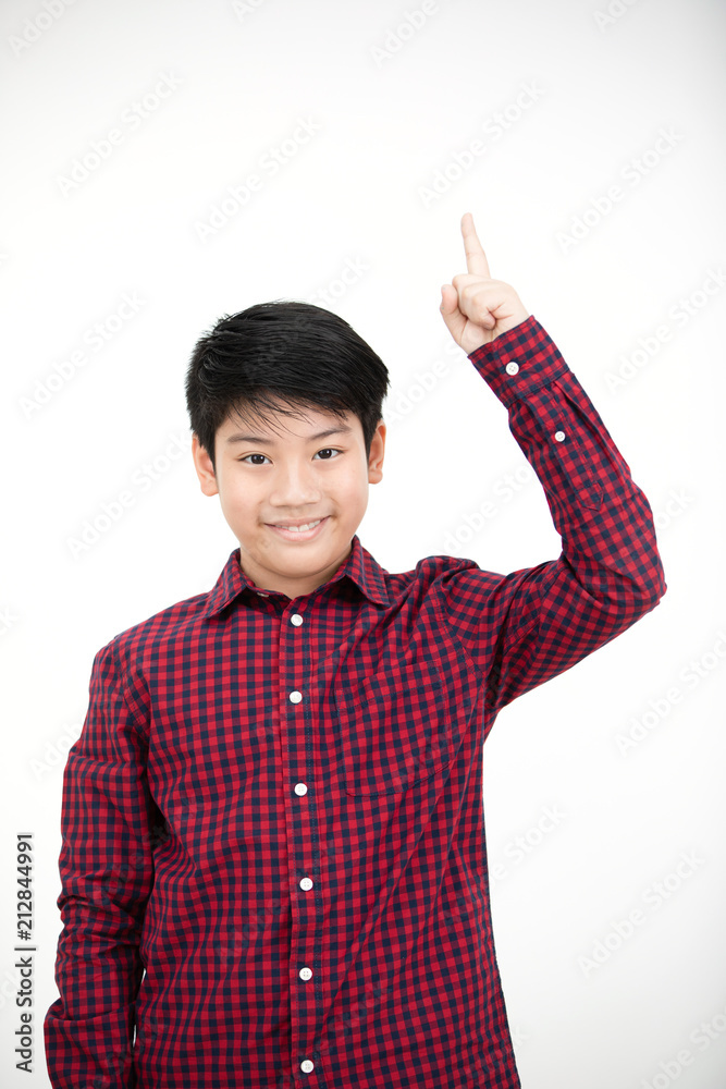 Asian boy smiling and pointing finger up . Asian boy smiling and pointing finger up .