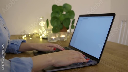 A woman typing at a macbook
