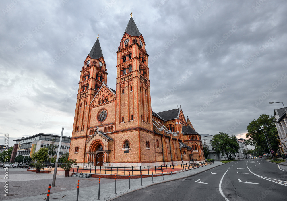 Nyiregyháza, Hungary - May 26, 2018: The twin-towered Nyiregyháza's Roman Catholic church with the newly built fountain in the foreground