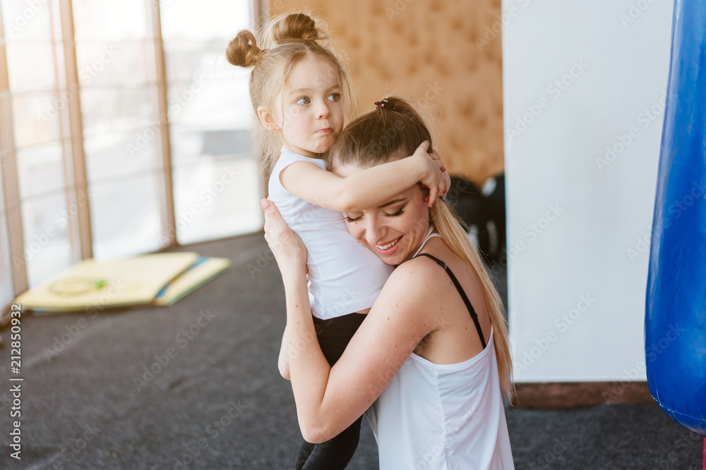 Mom hugs her little daughter Mom hugs her little daughter