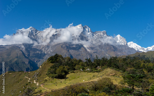 Kongde mountain peak behind pine tree forest, Himalayas mountain, Nepal photo