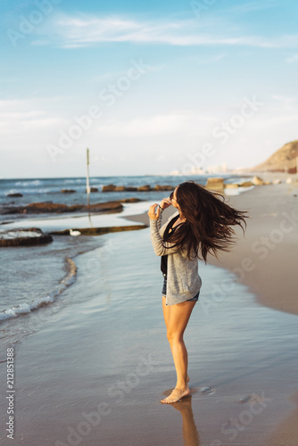 Young beautiful girl posing by the sea