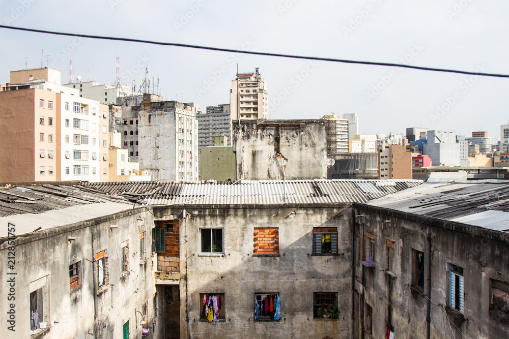 A ruined abandoned c shape building with square windows in San Paolo, Brazil, used as slum by a social housing movement. No people.