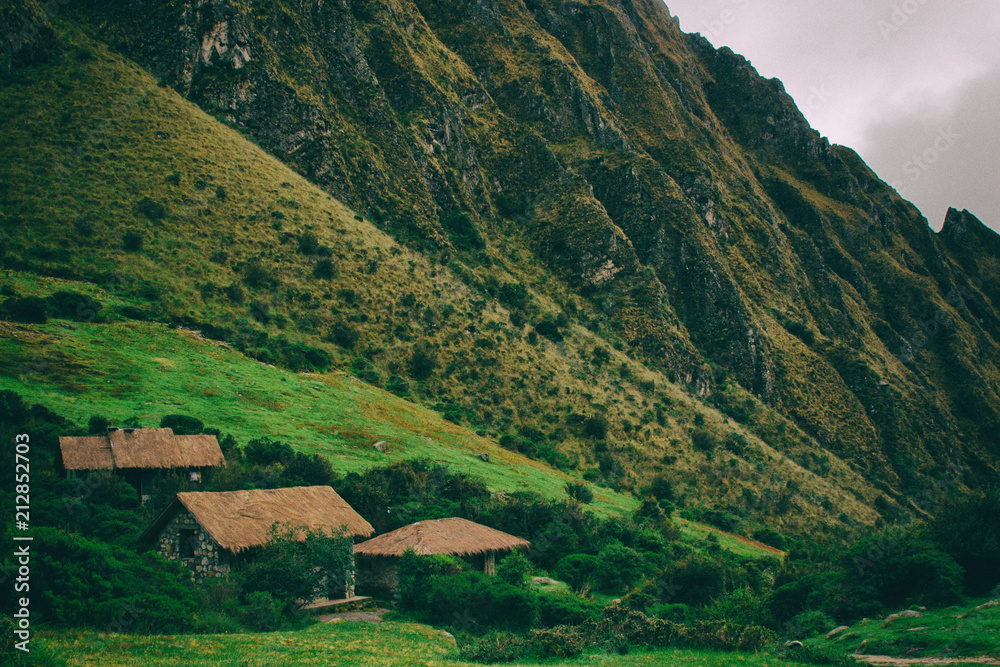 Along the Inca Trail houses are seen in Andes panorama. Peru. South America. No people.