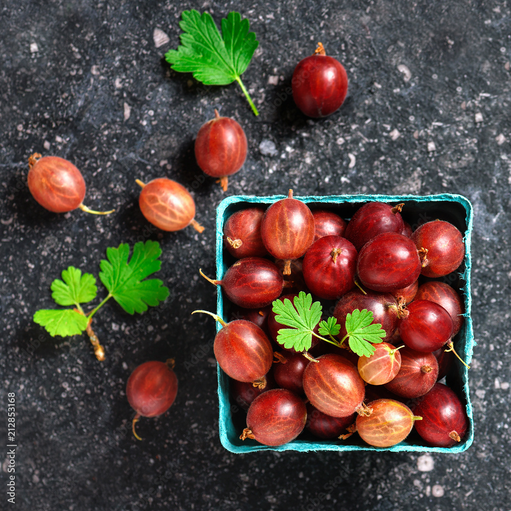 Ripe gooseberries fruit in cardboard box. Top view. Square image.