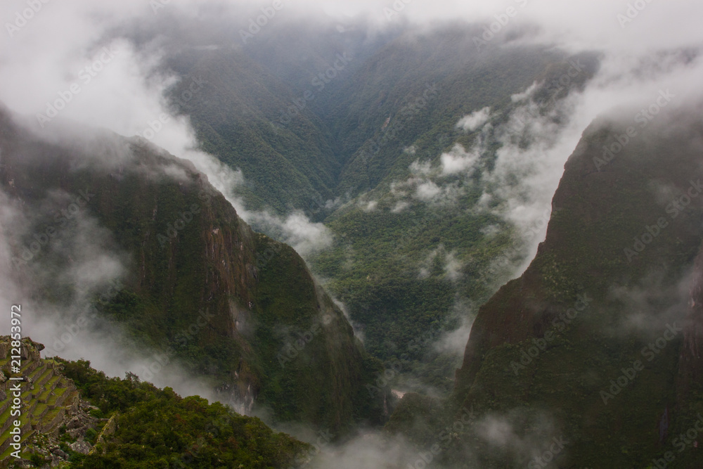 Green wild jungle valley with fog from a high point of view on the Andes along the Inca Trail. Peru. South America. No people.