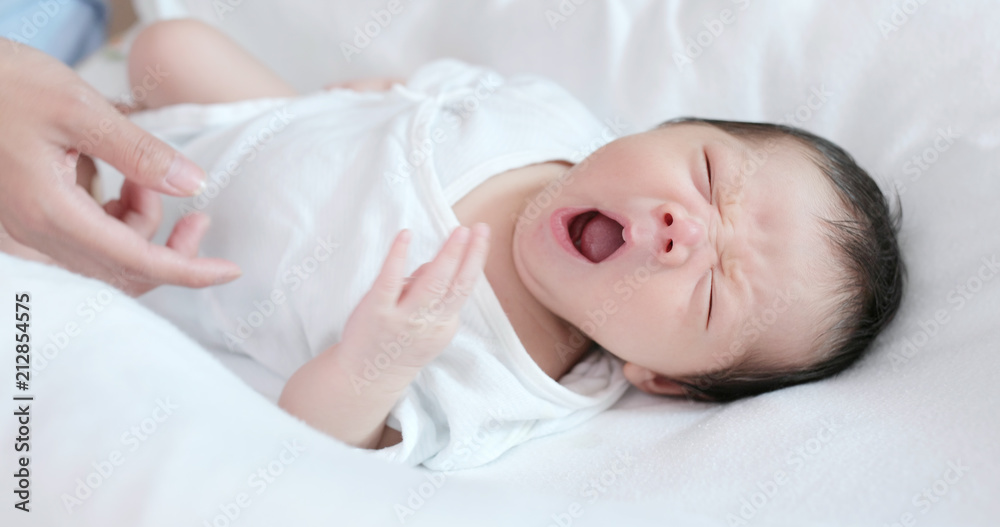 New born baby feeling relax with mother hand on his body New born baby feeling relax with mother hand on his body