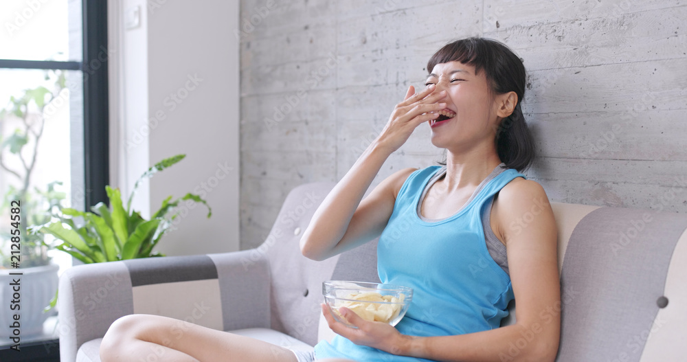Woman watching movie and eating snack at home Woman watching movie and eating snack at home