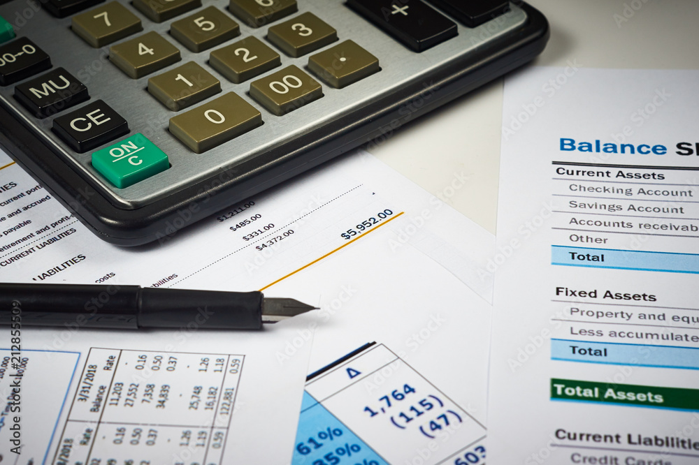 spreadsheet, balance sheets with calculator and pen