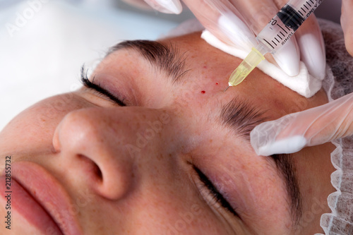 Beautician making injection in woman s face  closeup. Biorevitalization procedure