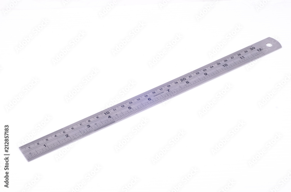 A metal ruler on a white background A metal ruler on a white background