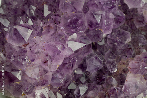 Amethyst geode background. Beautiful natural crystals gemstone. Extreme close up macro shot.