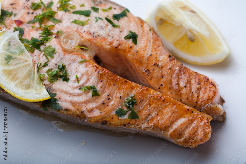 Salmon slice with a lemon and green parsley Salmon slice with a lemon and green parsley