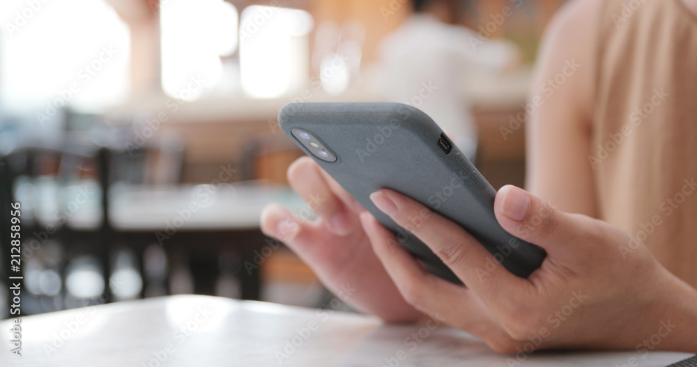 Woman use of mobile phone in restaurant