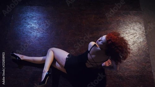 Young redhaired sexy strip dancer photo