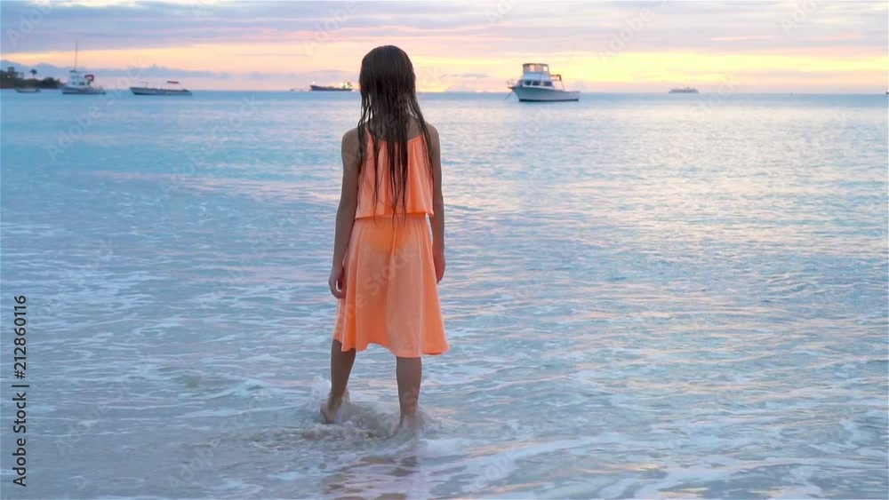 Sihouette of little girl on the beach at sunset. Sihouette of little girl on the beach at sunset.