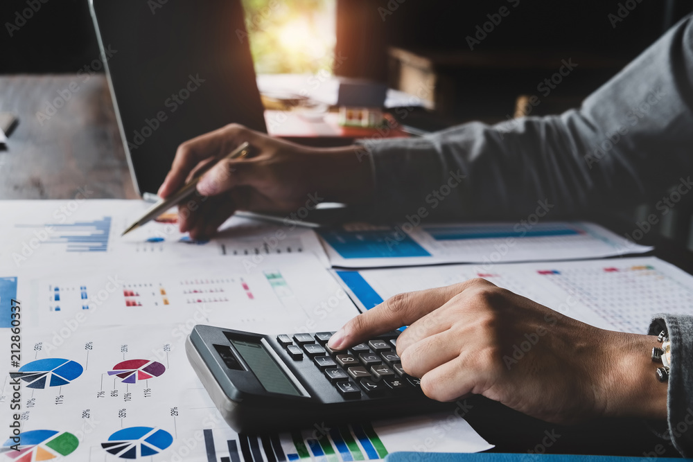 Bookkeeper accounting Concepts, Male use calculator, pen and computer laptop to monitor money saving reports budget to plan before retire. nspector accountant concept. Bookkeeper accounting Concepts, Male use calculator, pen and computer laptop to monitor money saving reports budget to plan before retire. nspector accountant concept.
