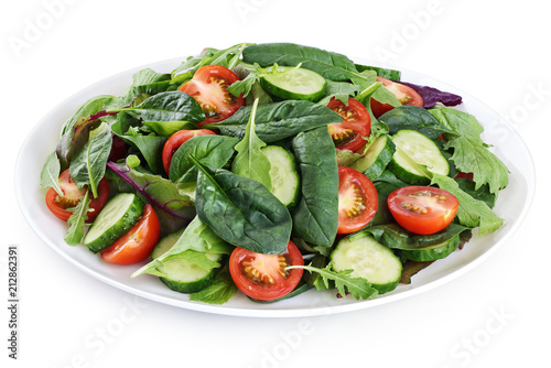 Fresh green salad with tomatoes isolated on white background.