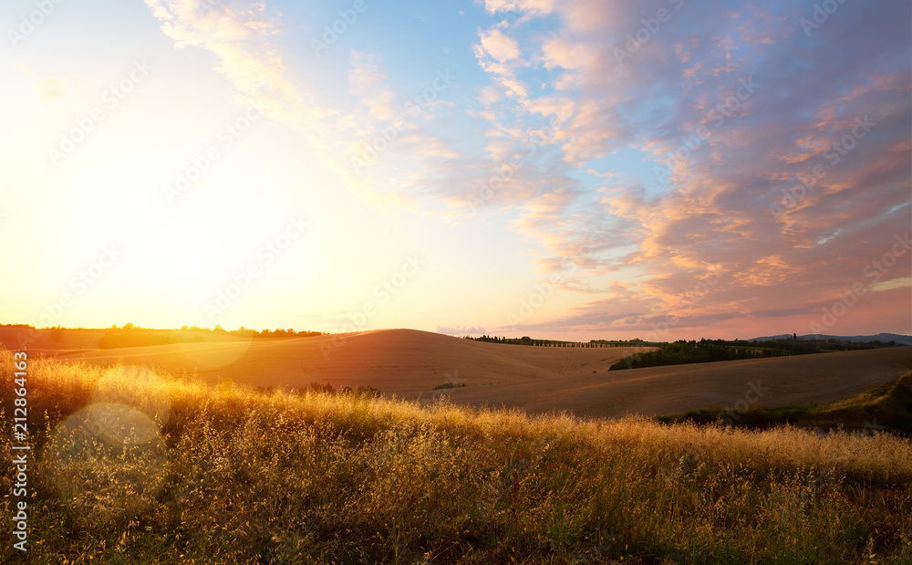 typical Tuscany landscape; sunset over rolling hills typical Tuscany landscape; sunset over rolling hills