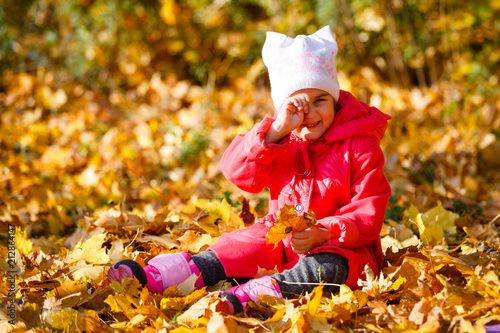 happy little child  baby girl laughing and playing in the autumn on the nature walk outdoors