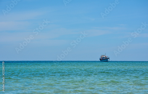 lonely fishing schooner in a quiet turquoise sea