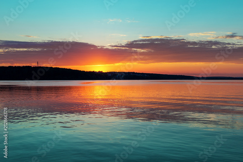 Gorgeous orange teal sunset on huge calm lake © Andrew