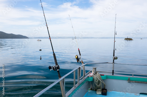 Fishing rods on a charter boat at sea in Far North District, Northland, New Zealand, NZ