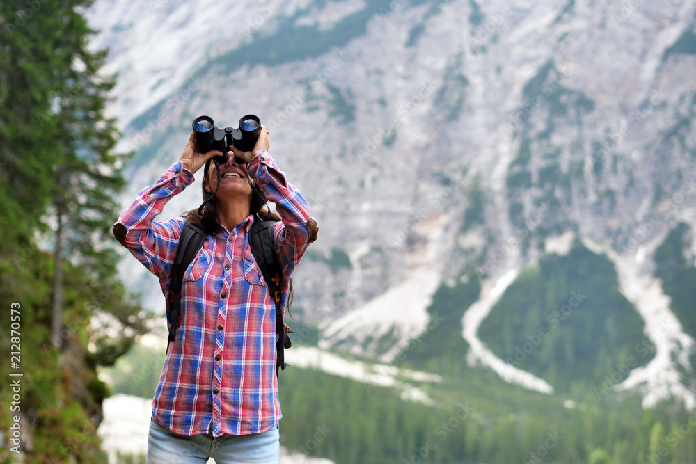 Portrait of a beautiful woman (girl) while she is looking at the mountains. Concept: Holiday, travel, happiness, freedom