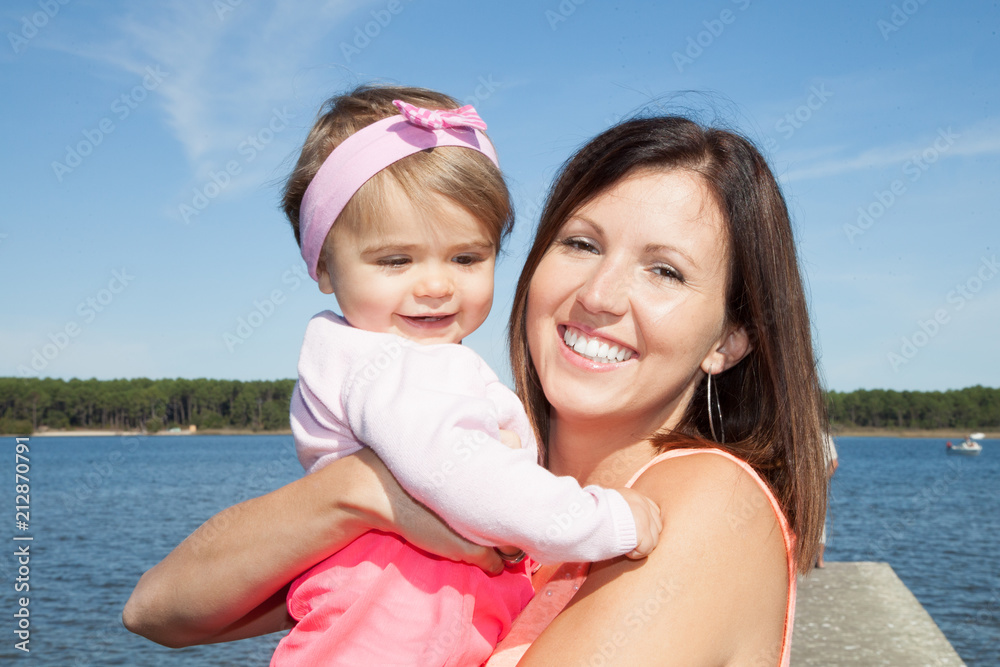 cute child girl with mother portrait in beach during vacation cute child girl with mother portrait in beach during vacation