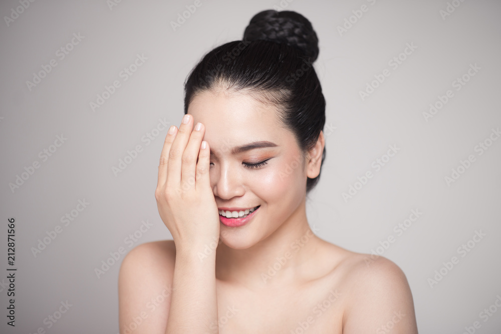 Happy smiling beautiful asian woman touching her face. Happy smiling beautiful asian woman touching her face.
