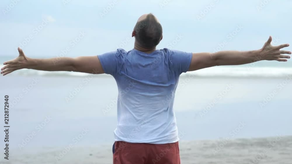Young man stretching arms and enjoying day on beach
Young man stretching arms and enjoying day on beach