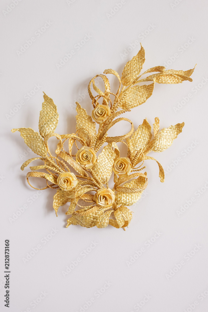 Decoration of straw on a white background. Branch with flowers. Decor. Decoration of straw on a white background. Branch with flowers. Decor.