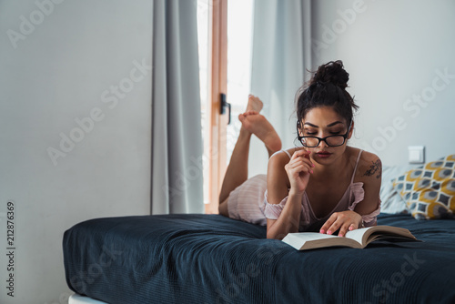 Alluring woman with eyeglasses and book photo