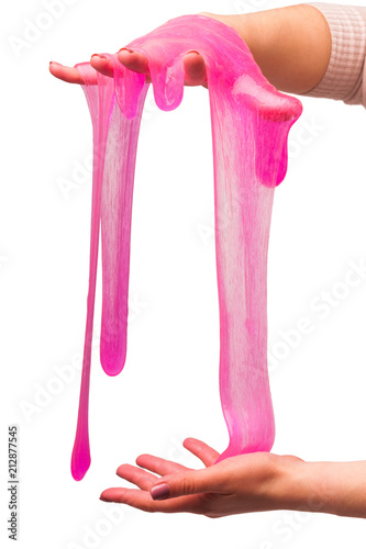 Obraz na płótnie a toy for children mucus and liquid flowing on hand on a white background