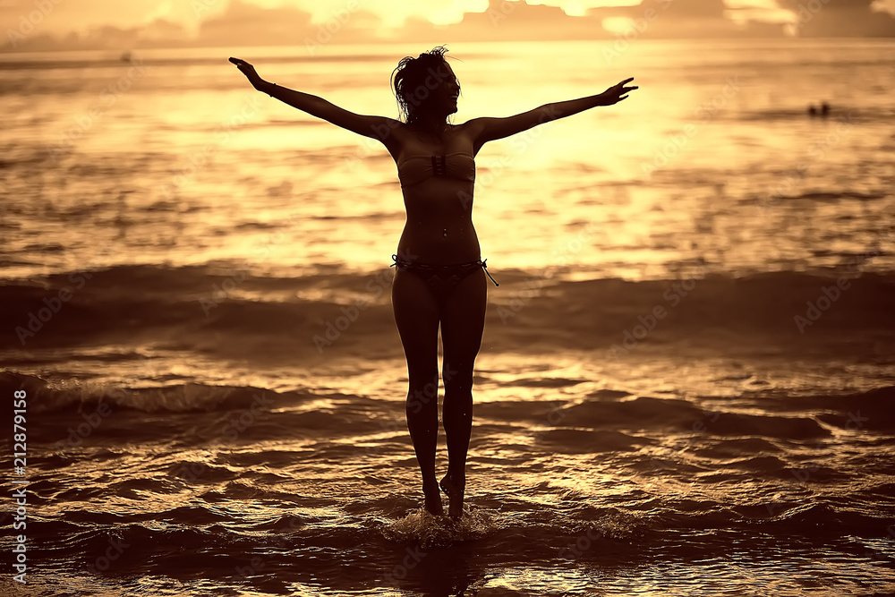 girl is having fun and jumping on beach freedom / concept freedom and summer beach, sporty graceful girl is jumping and having fun beach girl is having fun and jumping on beach freedom / concept freedom and summer beach, sporty graceful girl is jumping and having fun beach