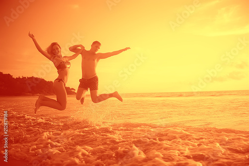 lovers run along the beach   guy and girl run along the summer sea beach  rest on the sea honeymoon