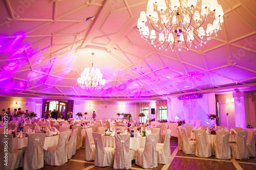 Canvas-taulu photo interior is a refined banquet hall with purple and pink light