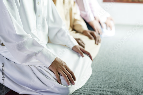 Muslim prayers in Tashahhud posture photo